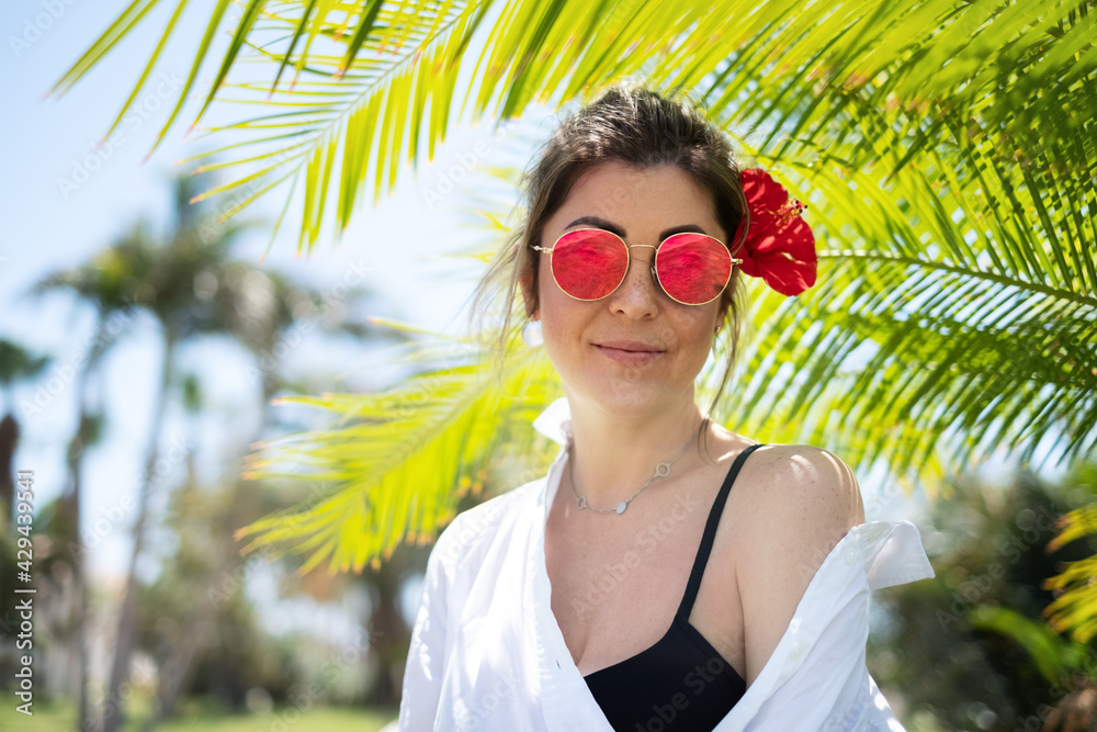 Beautiful wooman in a white shirt and red glasses Beautiful wooman in a white shirt and red glasses