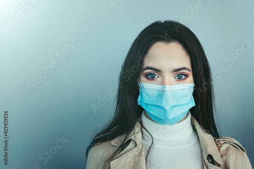 Closeup of  cute girl wearing a medical mask during pandemic of Coronavirus Covid-19 photo