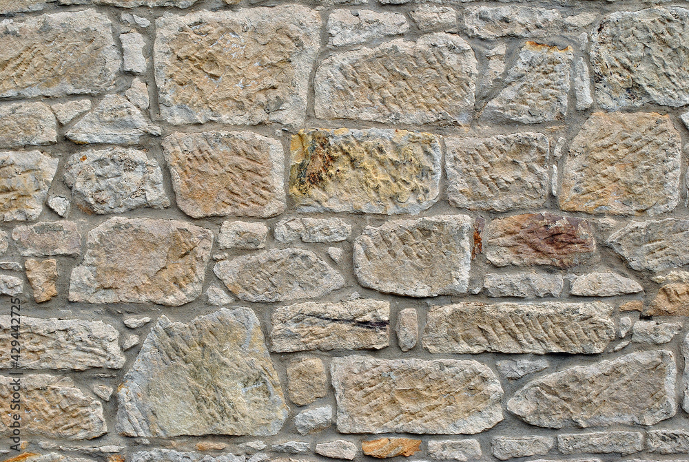 Close Up of Rough Textured Stone in Old Masonry Wall 