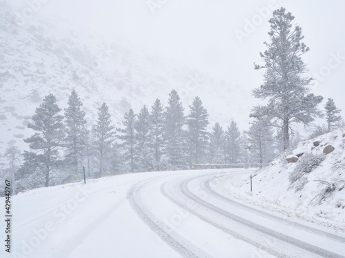 winter travel in Colorado Rocky Mountains - highway 14 in Poudre Canyon in a heavy early spring snowstorm © MarekPhotoDesign.com