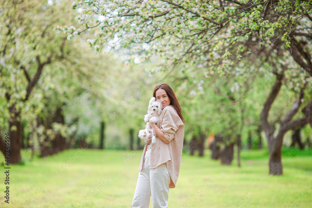 Woman playing and hugging puppy in the park Woman playing and hugging puppy in the park