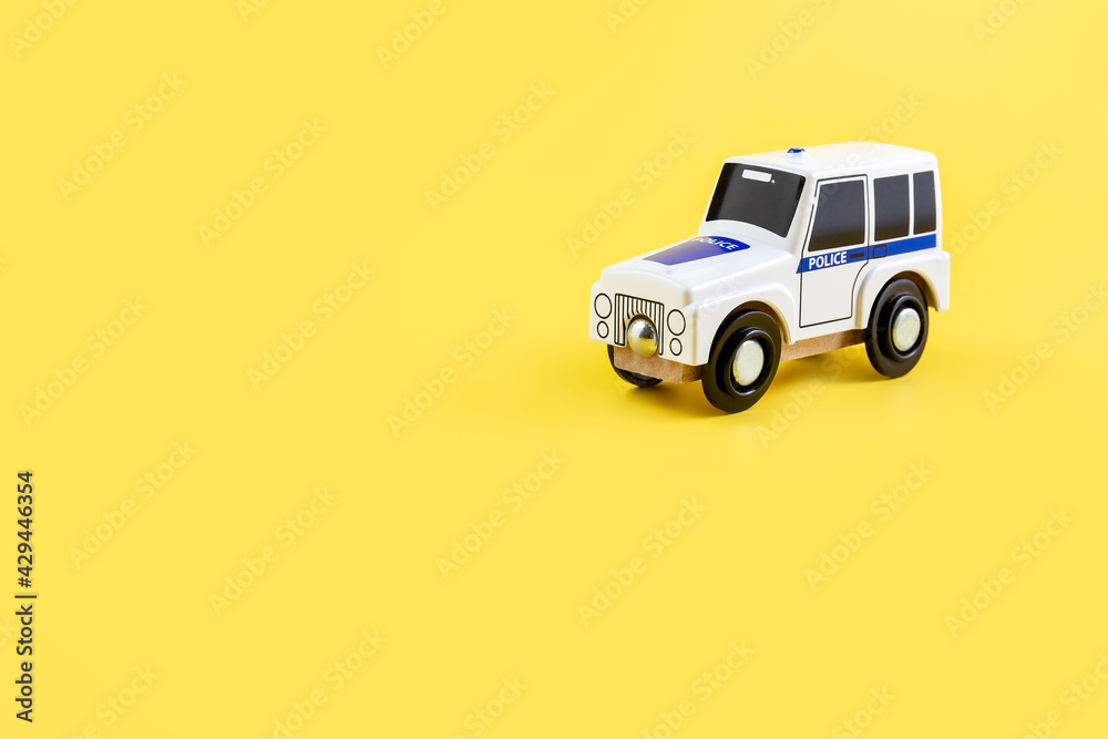Children's toy, car on a yellow background. Police car. Concept. Isolate. Copy space.