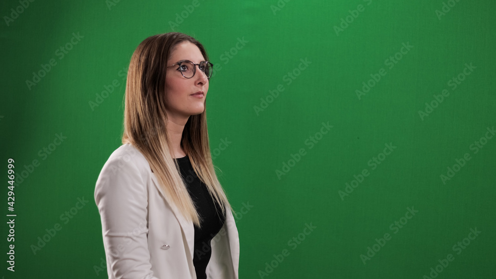 Young woman taps on a large imaginary touchscreen - studio photography Young woman taps on a large imaginary touchscreen - studio photography