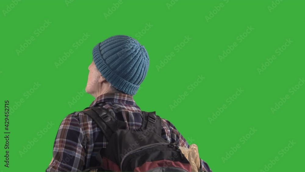 Backpacker looking around on a green screen medium shot Backpacker looking around on a green screen medium shot