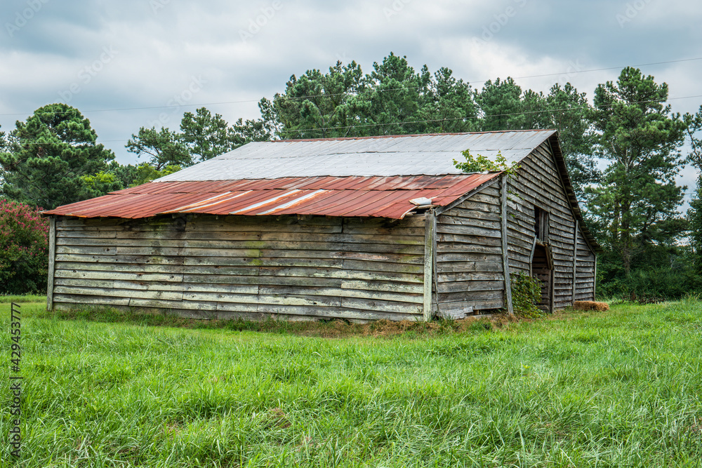 Abandoned barn in a farm field Abandoned barn in a farm field