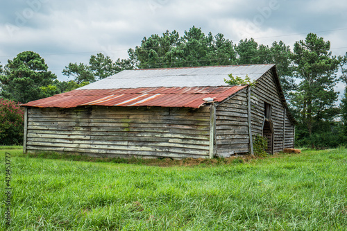 Abandoned barn in a farm field