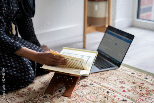 Black Muslim Woman studying quran photo