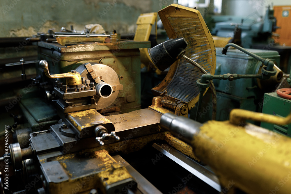 A lathe with a blank in the spindle. Old equipment at the factory from the mid-20th century. A lathe with a blank in the spindle. Old equipment at the factory from the mid-20th century.