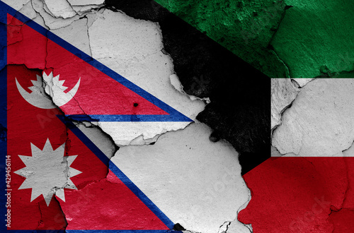 flags of Nepal and Kuwait painted on cracked wall