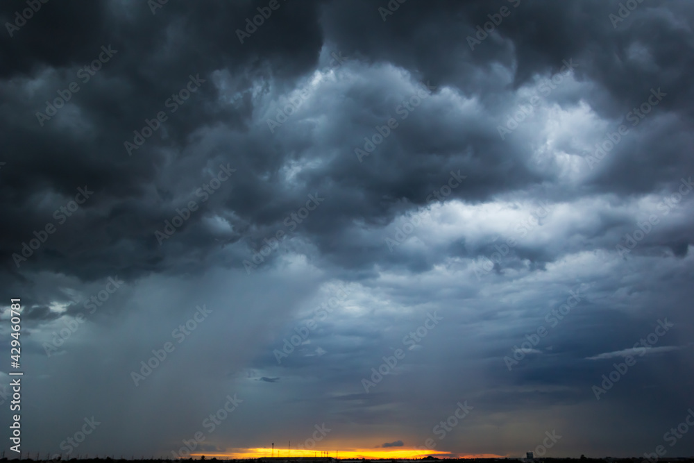 The dark sky had clouds gathered to the left and a strong storm before ...
