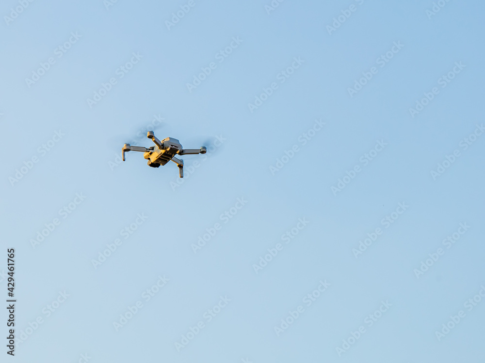 Drone Flying with action camera. Isolated on Sky Background. Drone Flying with action camera. Isolated on Sky Background.