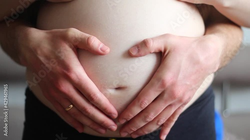 Wallpaper Mural Pregnant woman and her future dad are stroking a big belly. The concept of future caring parents. Close-up Torontodigital.ca