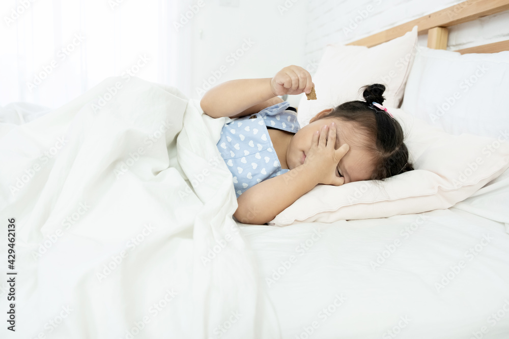 Cute little Asian toddler girl tired and sleepy in bed Cute little Asian toddler girl tired and sleepy in bed