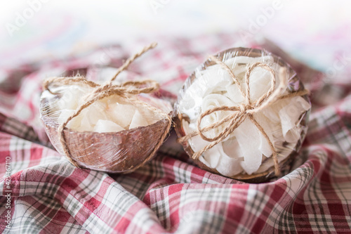 Coconut dried candies stored in coconut shells decor with rope