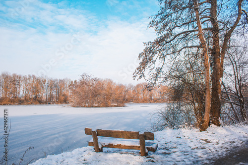 Winter landscape in Braunschweig, Lower Saxony, Germany. Snow covered Westpark and frozen lake on a winter day