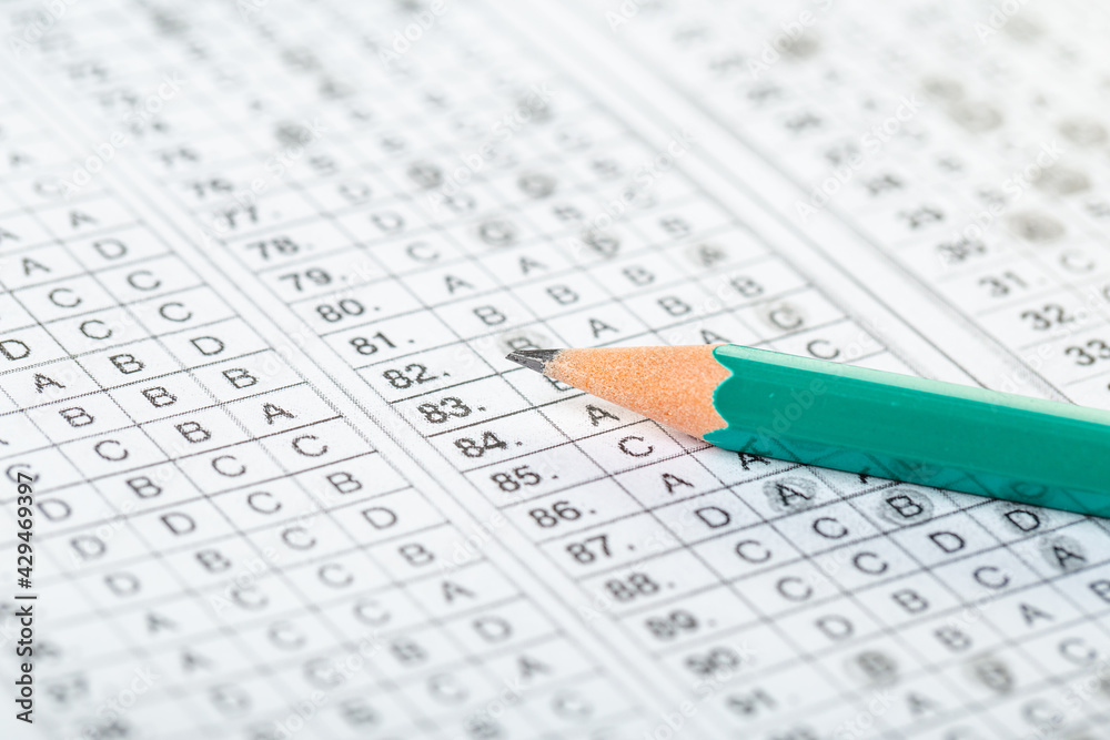 testing in exercise and exam paper. computer sheet with pencil in school test room, education concept. filling in answers in pencil testing in exercise and exam paper. computer sheet with pencil in school test room, education concept. filling in answers in pencil