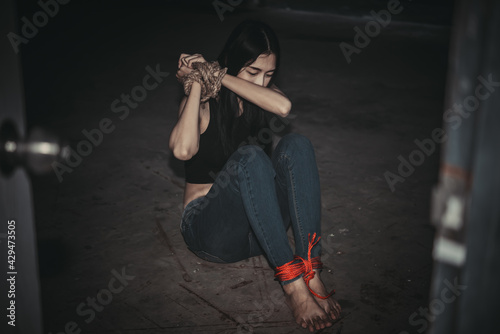 Asian hostage woman Bound with rope at night scene,The thieves kidnapped for ransom,thailand people
