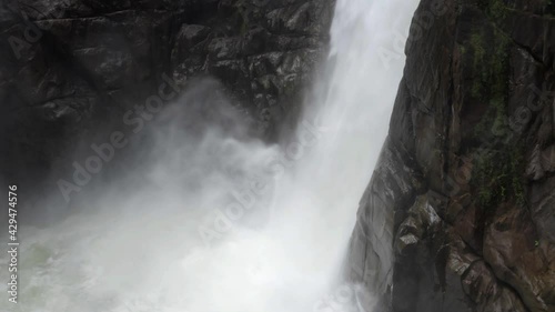 Still video of a very large waterfall showing the water plummeting down and leaving a layer of waterdamp behind