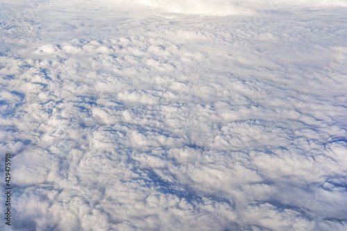 Fluffy clouds that looks as flat surface as seen from commercial airplane