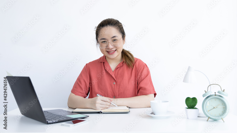 Young Asian women are greeting friends and teachers through video chats and greeting them with cheerful expressions, Online communication , Stay home, New normal, Covid-19 coronavirus. Young Asian women are greeting friends and teachers through video chats and greeting them with cheerful expressions, Online communication , Stay home, New normal, Covid-19 coronavirus.
