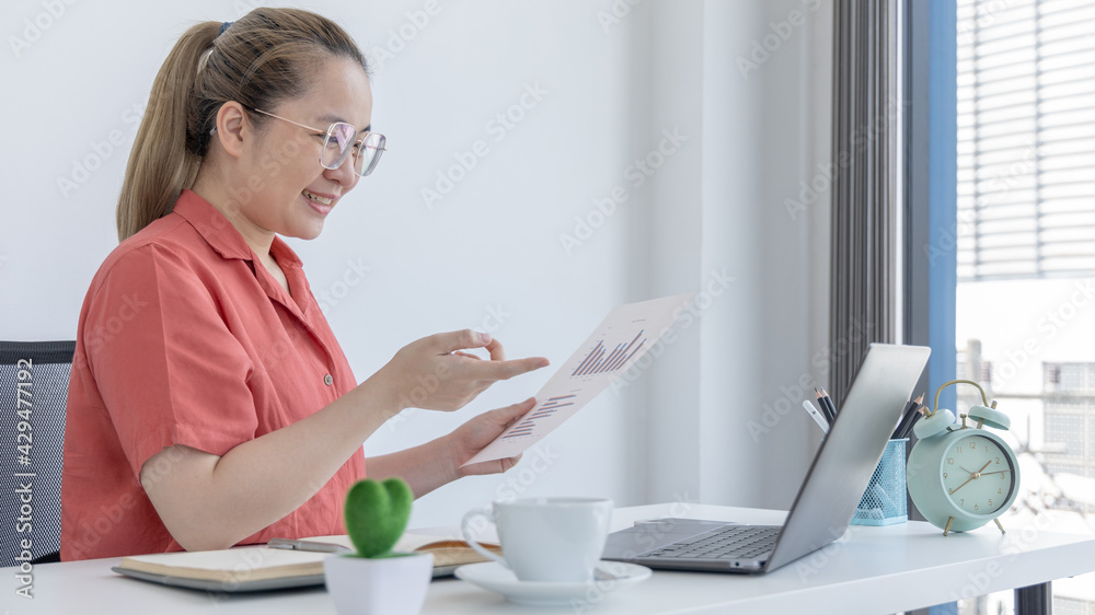 Young Asian women are greeting friends and teachers through video chats and greeting them with cheerful expressions, Online communication , Stay home, New normal, Covid-19 coronavirus. Young Asian women are greeting friends and teachers through video chats and greeting them with cheerful expressions, Online communication , Stay home, New normal, Covid-19 coronavirus.