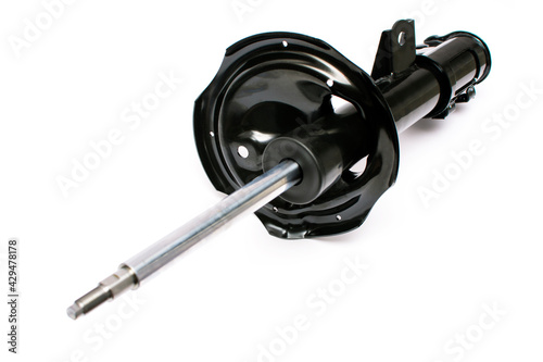Front strut hydraulic shock absorber with fastening loops and coil spring seat. Vehicle suspension system car. Spare part isolated on white background.