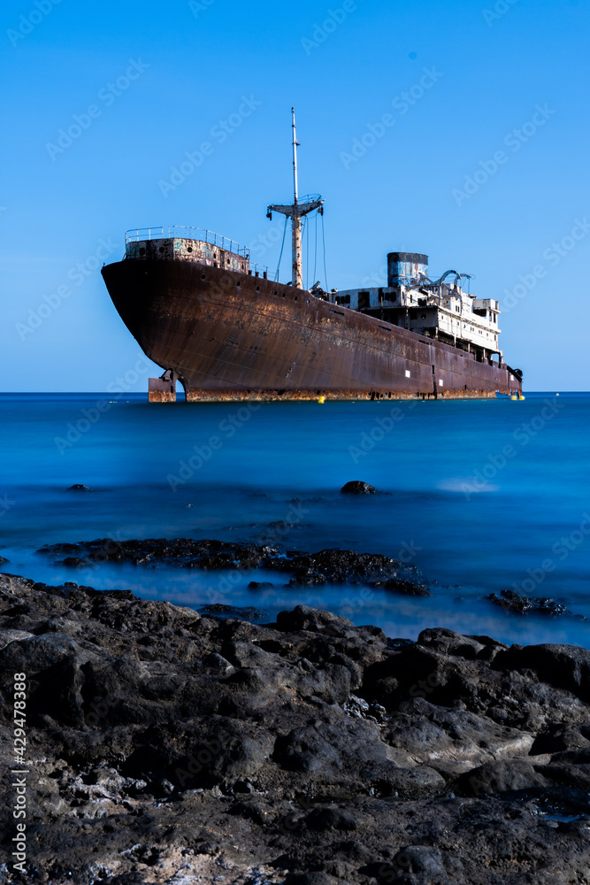 ship wreck in the sea with silk water and long exposure