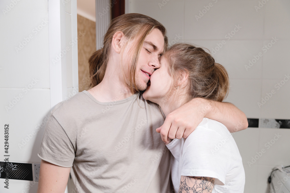 Young caucasian family couple man and woman laughing hugging in bathroom Young caucasian family couple man and woman laughing hugging in bathroom