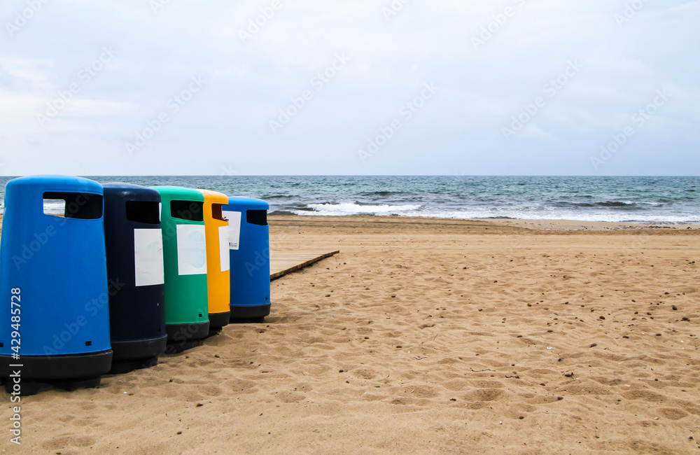 Colorful Wastebaskets and walkway to the beach Colorful Wastebaskets and walkway to the beach