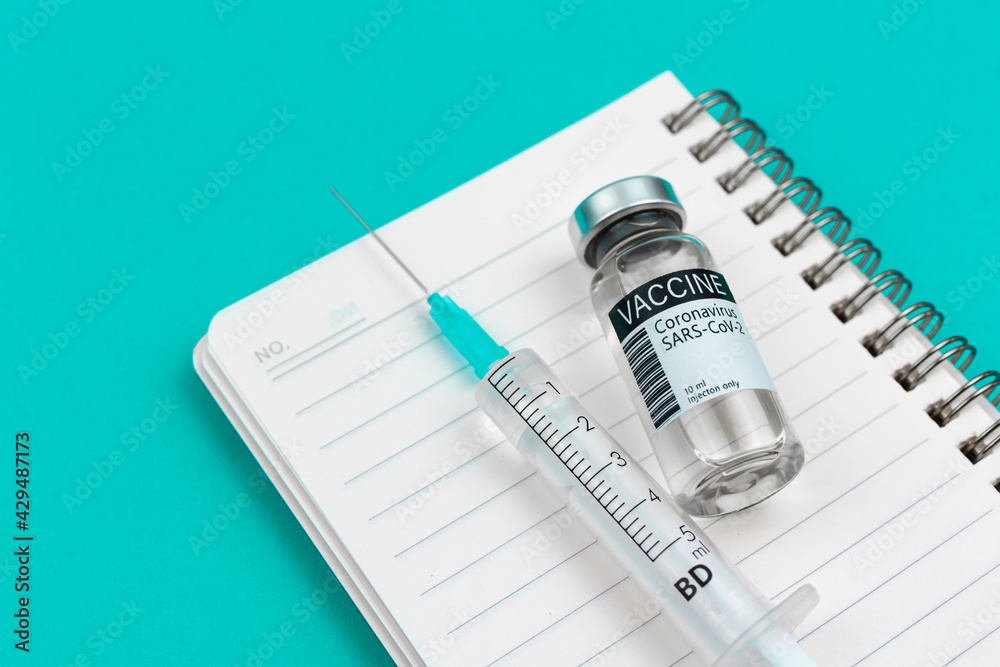 Coronavirus vaccination background with vaccine vial and medical syringe, medicine and healthcare cure concept photo Coronavirus vaccination background with vaccine vial and medical syringe, medicine and healthcare cure concept photo