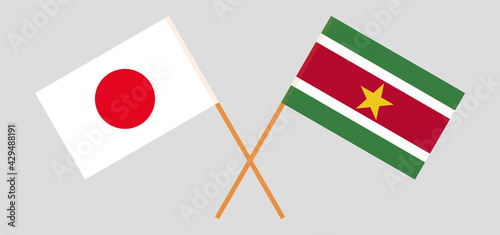 Crossed flags of Japan and Suriname. Official colors. Correct proportion