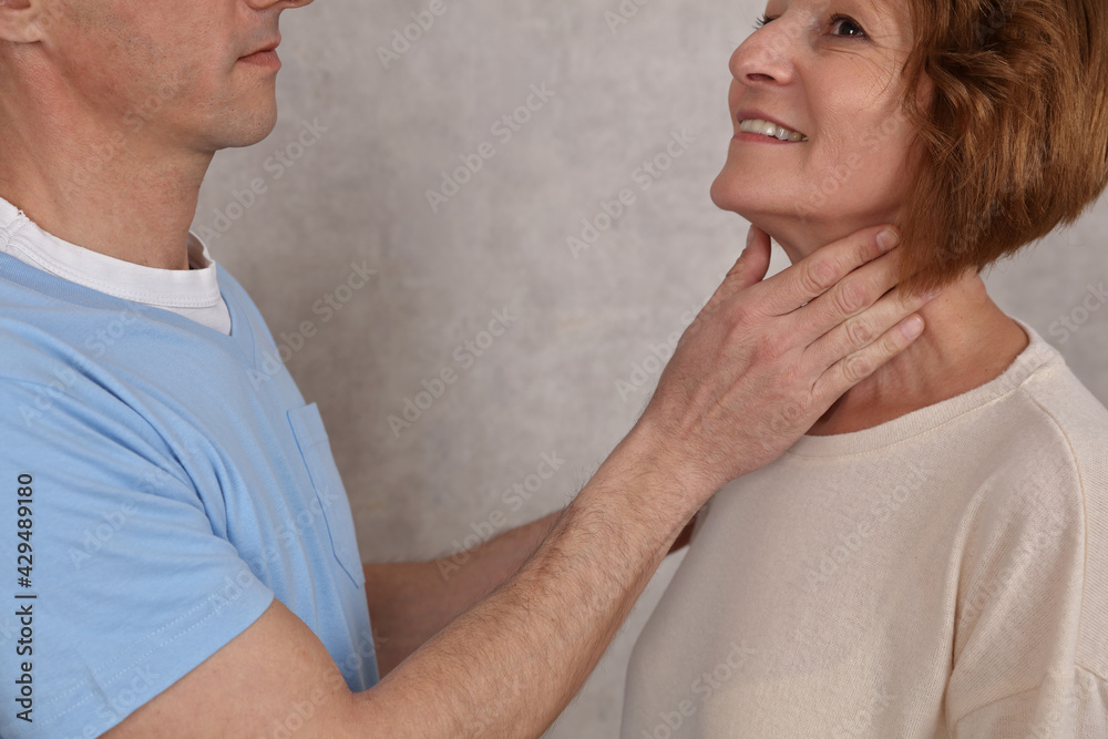 Mature woman getting thyroid gland control. Health care and medical concept Mature woman getting thyroid gland control. Health care and medical concept