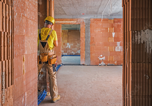 Professional Construction Worker Inside Brick Built Building