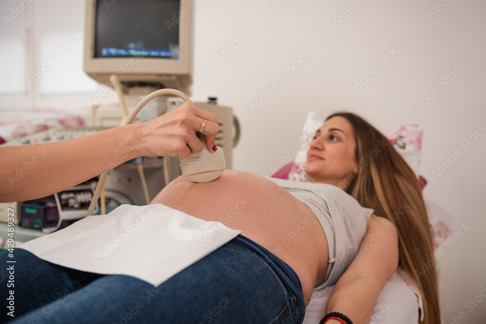 Unrecognizable doctor examining pregnant woman Unrecognizable doctor examining pregnant woman