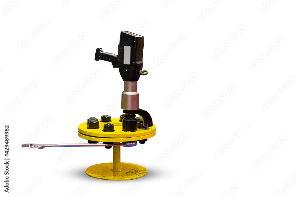 close up digital electric torque wrenches and combination wrench during assembly tighten bolt and nut with work piece on ground isolated with clipping path close up digital electric torque wrenches and combination wrench during assembly tighten bolt and nut with work piece on ground isolated with clipping path