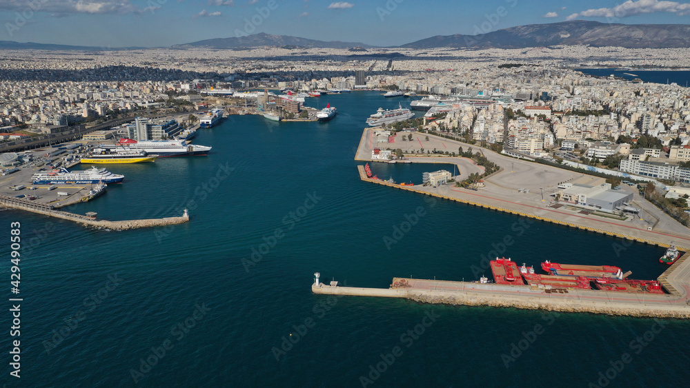 Aerial drone panoramic photo of famous and busy port of Piraeus where passenger ships travel to popular Aegean destinations, Attica, Greece