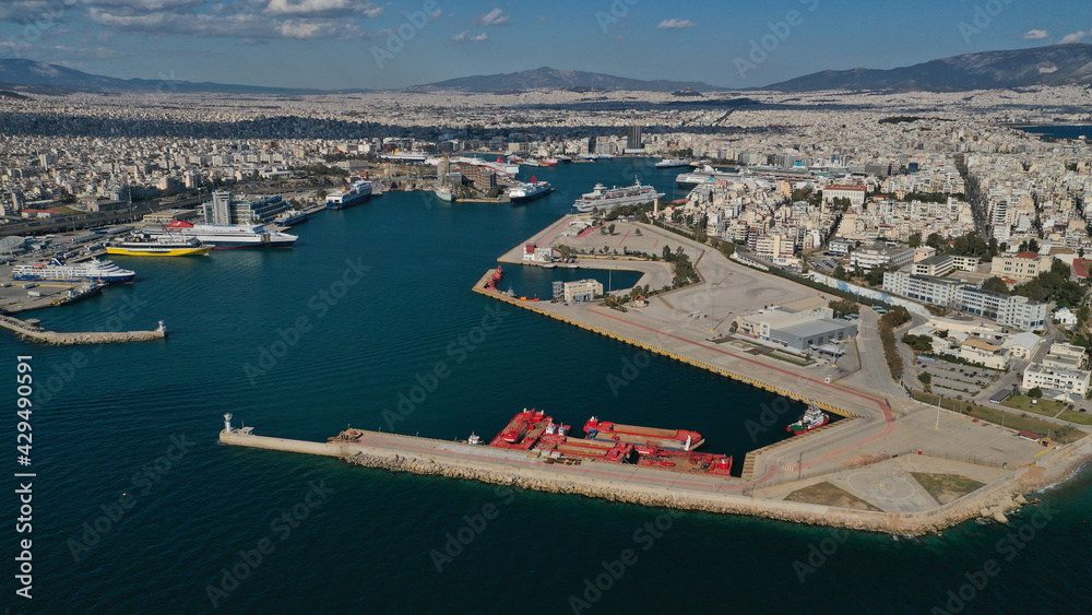 Aerial drone panoramic photo of famous and busy port of Piraeus where passenger ships travel to popular Aegean destinations, Attica, Greece