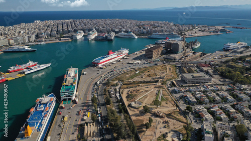 Aerial drone photo of iconic busy port of Piraeus and archaeological site - Ruins of the Eetioneia   ancient walls of Piraeus  Attica  Greece