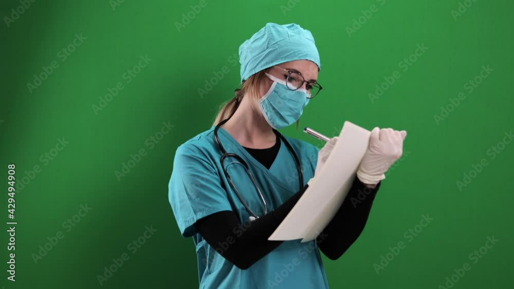Female doctor takes notes in a file - studio photography Female doctor takes notes in a file - studio photography