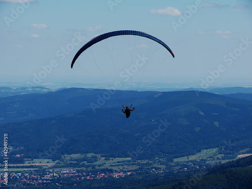 The paraglide over mountains near Karpacz in Poland