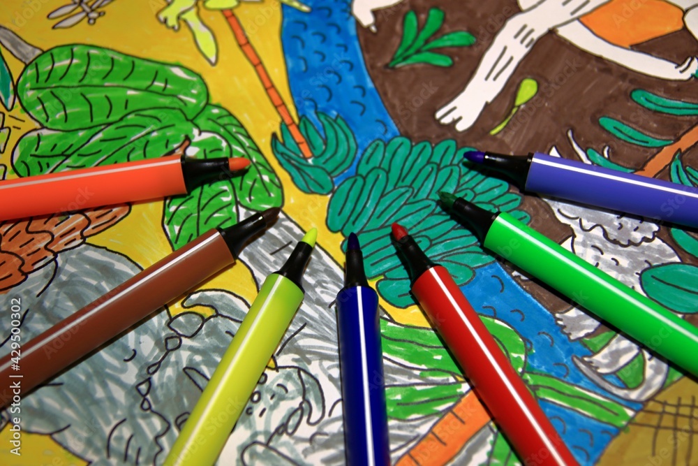 Colored markers on a child's drawing