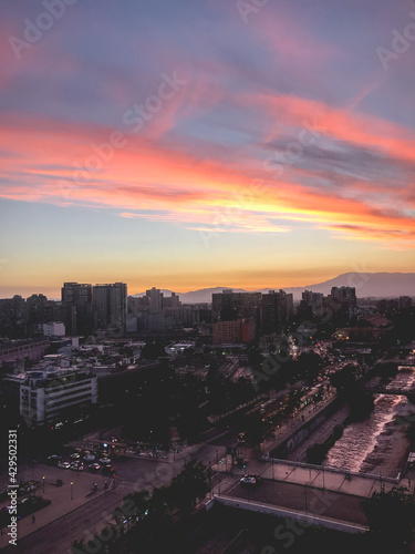 Panoramic view of beautiful and colorful clouds and sunset sky over Santiago downtown skyline and, Chile