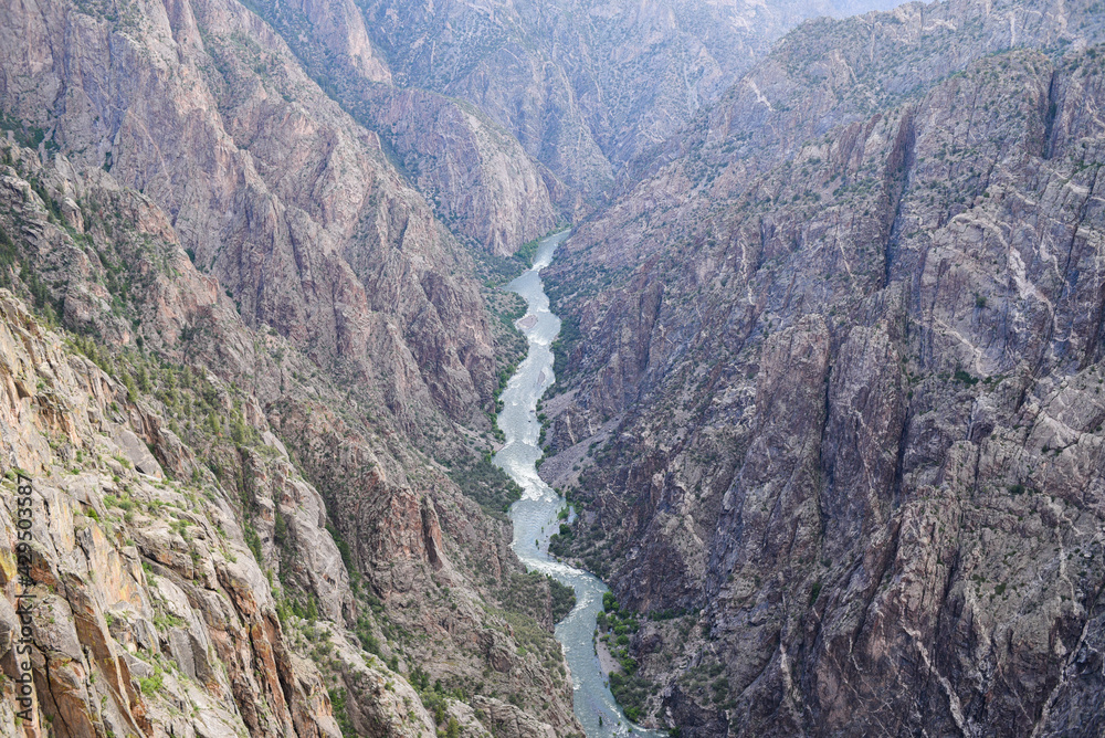 a river carving its way through a massive canyon a river carving its way through a massive canyon