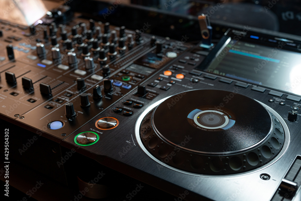 Fototapeta premium Player and mixing console closeup. DJ equipment