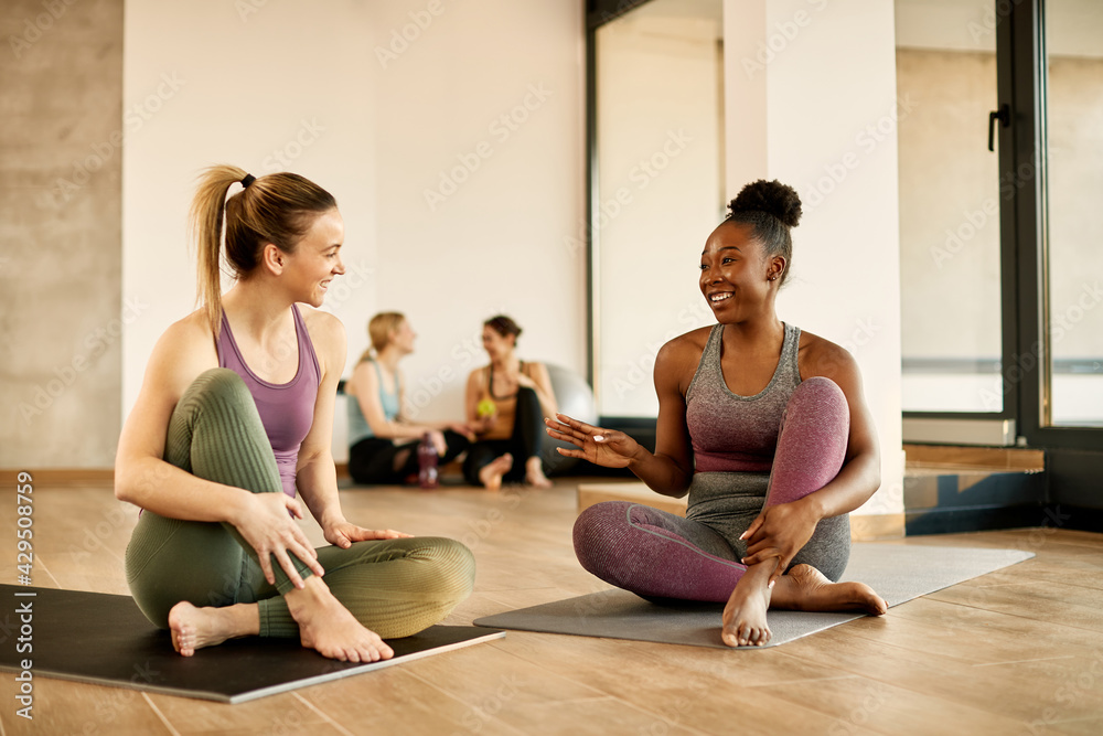 custom made wallpaper toronto digitalHappy female athletes talking while relaxing on the floor at health club.