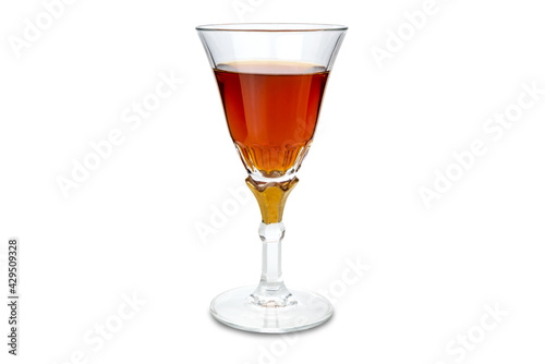 Marsala wine in goblet glass with gold decoration. Isolated on white, copy space