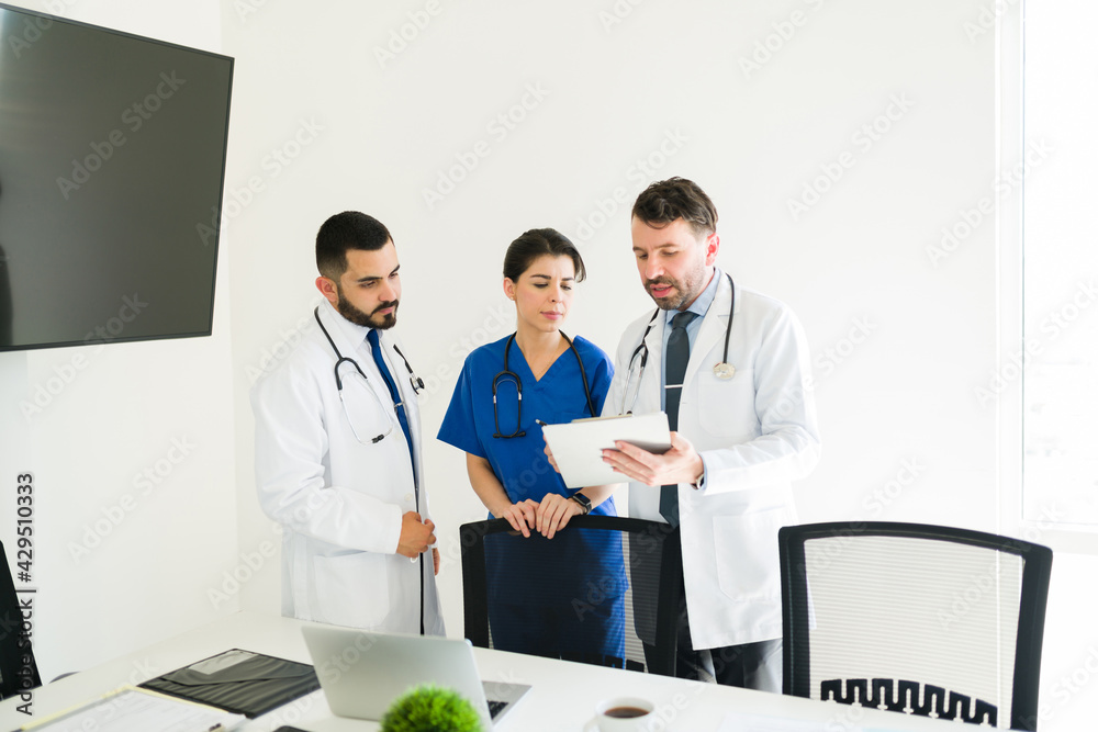 Hospital board working together on a medical case Hospital board working together on a medical case