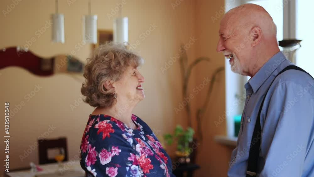 Happy senior couple embracing and dancing together at home
Happy senior couple embracing and dancing together at home