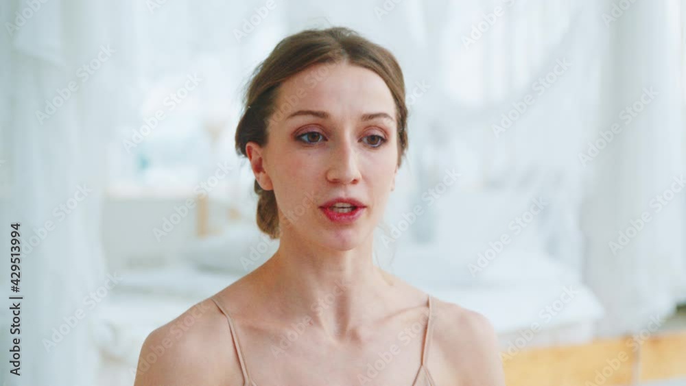 Attractive yoga coach explaining online videos. Young girl talking on an online conference Attractive yoga coach explaining online videos. Young girl talking on an online conference