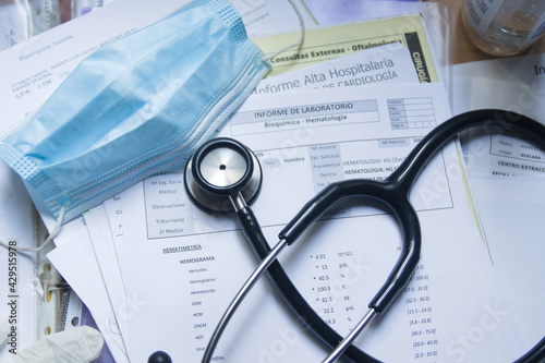 A stethoscope on some medical reports of a patient in a hospital